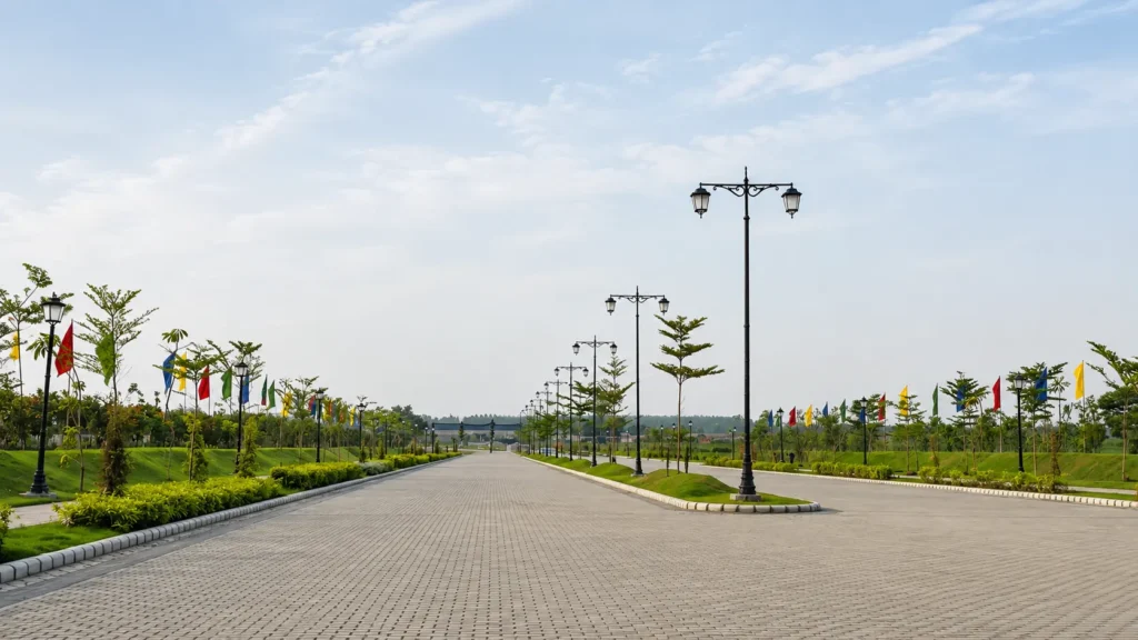 Omaxe New Ludhiana internal road with landscaped greenery and street lights