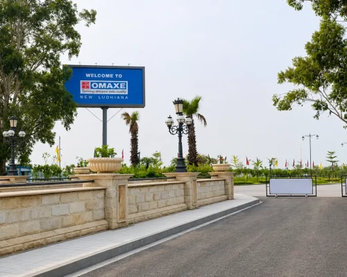 Omaxe New Ludhiana entrance gate with landscaped surroundings